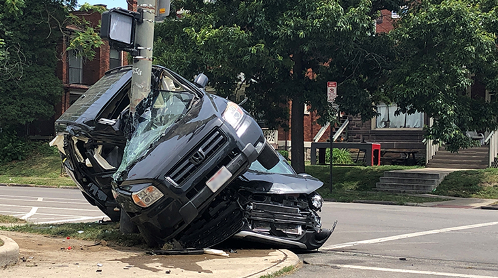2 hospitalized after SUV wrapped around utility pole during north